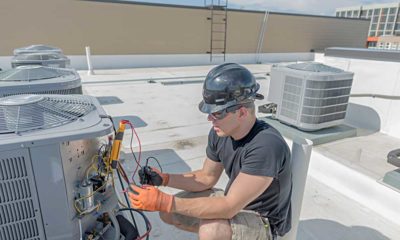 Commercial HVAC technician working on rooftop equipment